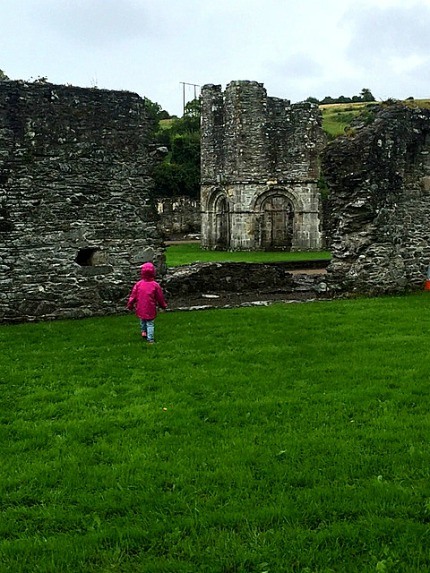 whatever the weather, my daughter explores mellifont abbey during our Boyne valley day tour