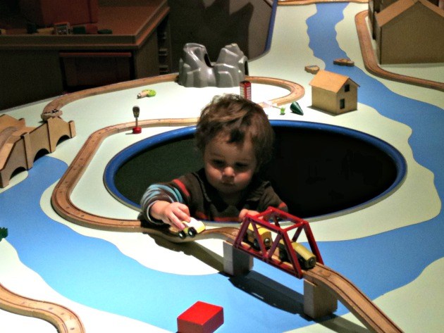 Mr M as a toddler playing with wooden trains and cars in Imaginosity, Dublin's children museum and one of the best rainy day activities for kids in Dublin