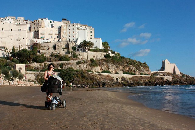 Me on the beach with our first travel pushchair