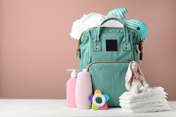 Green backpack diaper bag with baby gear