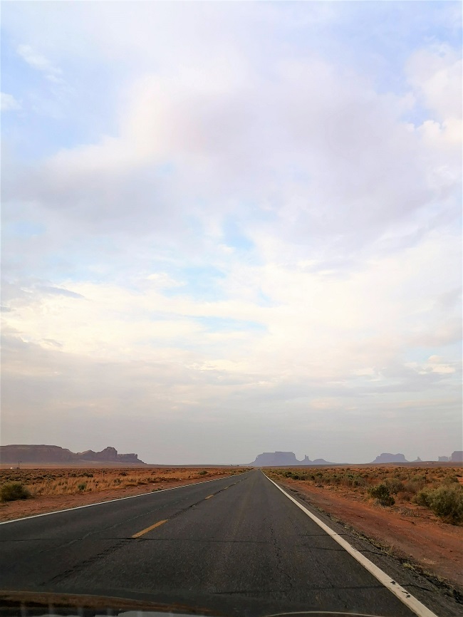 Drive to Monument Valley landscape with road and the buttes in the distance