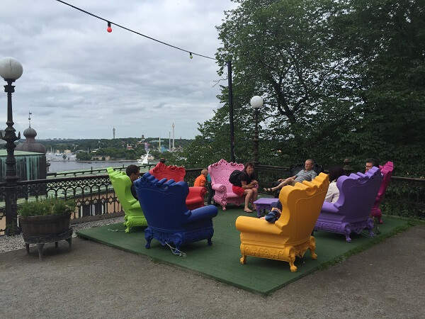 Sodermalm, Stockholm with colorful chairs on a terrace overlooking the sea