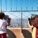 Kids looking out towards Manhattan from the top of the Empire State Building new York City