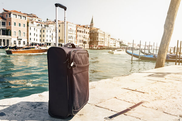traveling bag beside Venice canal Italy
