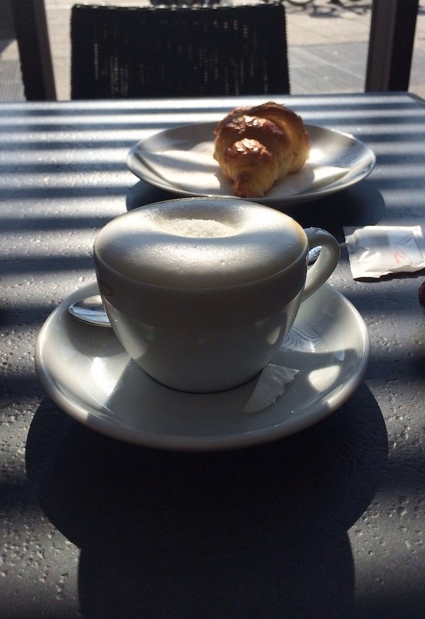 frothy cappuccino and cornetto pastry