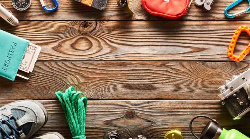 hiking essentials on wooden surface