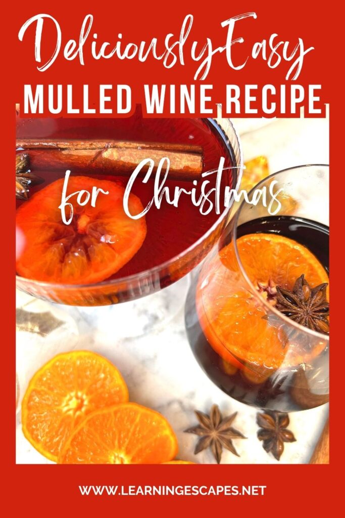 close up of two glasses of mulled wine on marble table with ingredients and text: deliciously easy mulled wine recipe for Christmas