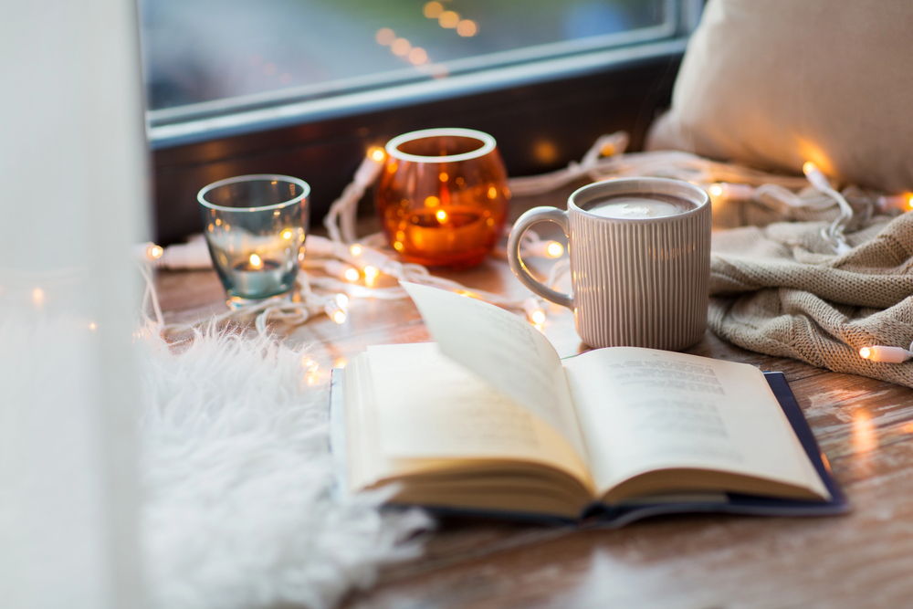 cozy home corner with hot drinks and a book